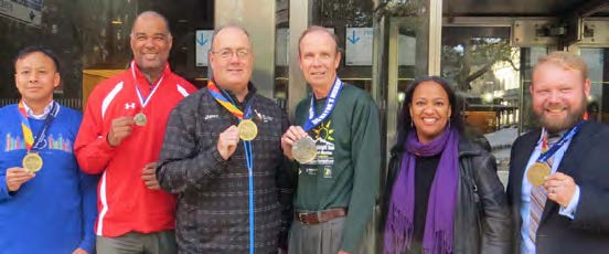 marathon runners with medals
