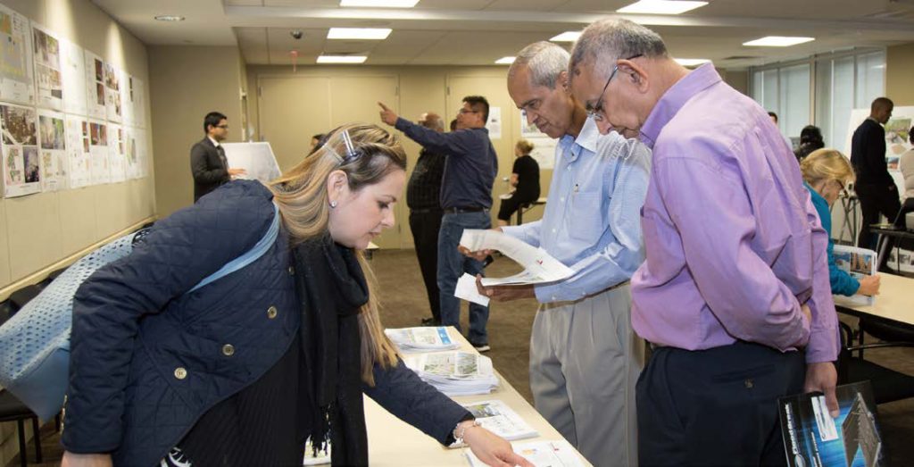 people looking at information table