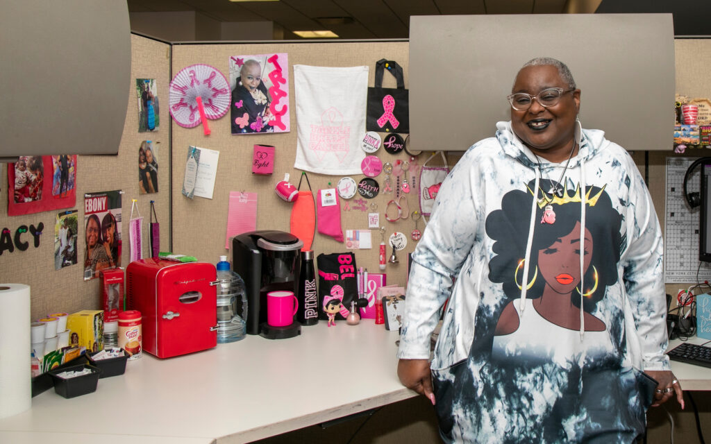 woman standing inside cubicle