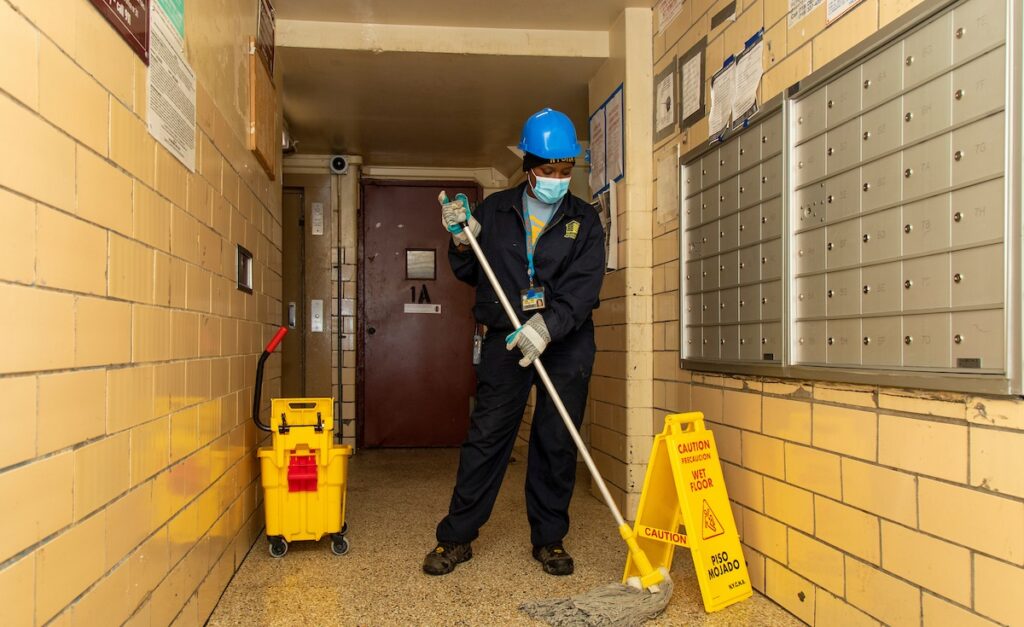 Caretaker mopping hallway