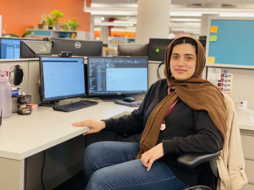 woman in hijab seated at desk