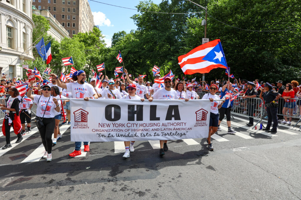 group of people with banner marching in parade