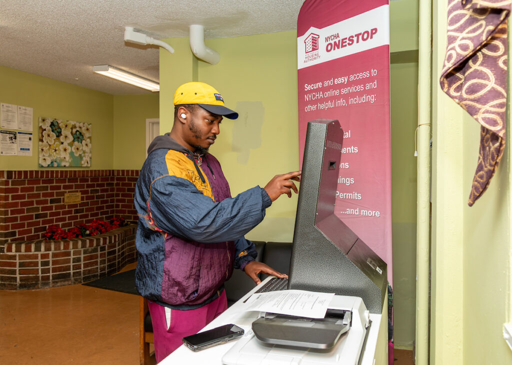 man using the touch screen of the Self-Service Kiosk