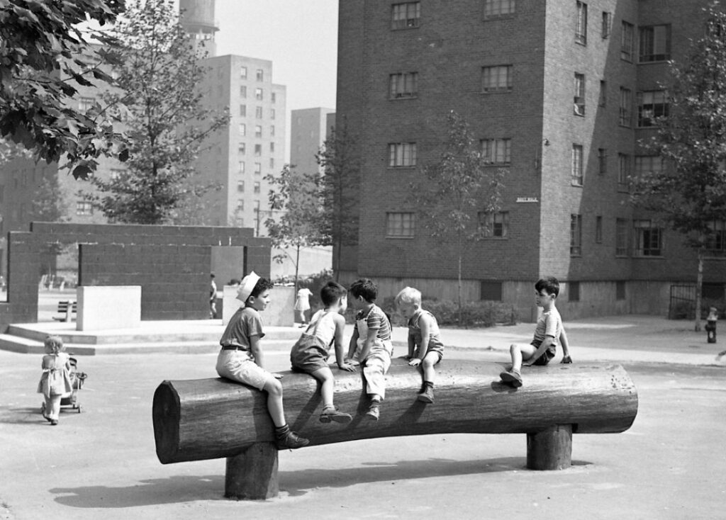 archival black and white photo of children playing at a NYCHA development.