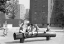 archival black and white photo of children playing at a NYCHA development.