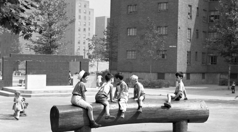 archival black and white photo of children playing at a NYCHA development.