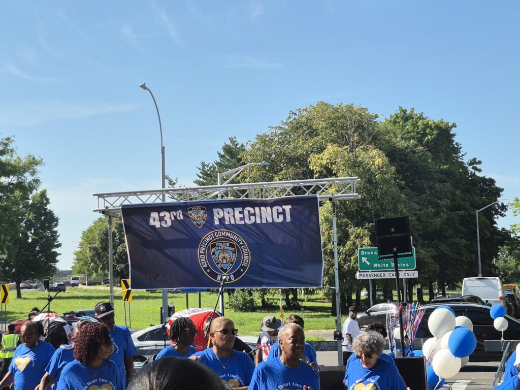 people standing below a sign for the 43rd precinct