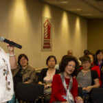 Former CAA Board Member Na Na Sun sings “The Invisible Wings.” Dragon Boat Festival