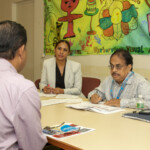 Minorka Cabrera, Assistant Director of the Lead Hazard Control Department, (left) and Raj Radhakrishnan, Director of the Lead Hazard Control Department, interview an attendee Job fair