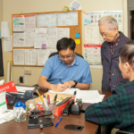Grayson Lin assisting LaGuardia Addition residents. On-site senior services