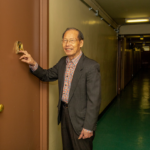 Floor Captain Fai Chan knocks on a resident's apartment door. On-site senior services