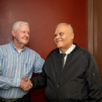 Floor Captain Richard Rosado visits with a neighbor. On-site senior services