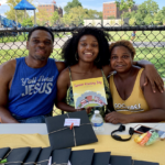 Shaniqua Lewis with her parents and her book. Summer Housing Boy author