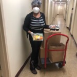 A volunteer helping to distribute meals.