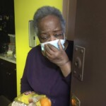 A resident receiving a donated meal from La Fonda Boricua restaurant.