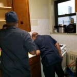 A maintenance worker caulking in an apartment. Note: Photo taken pre-COVID-19.