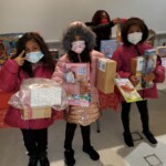Children hold toys they received at a toy giveaway held by the Van Dyke Houses Resident Association on Christmas Eve.