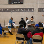 COVID-19 Vaccine Distribution at Van Dyke Houses Community Center. group of people in community center auditorium