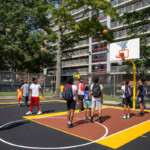 Local youth are among the first to test out the refurbished play space. Youth play at Stapleton court