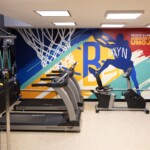 The renovated fitness area also received murals with community-focused themes.